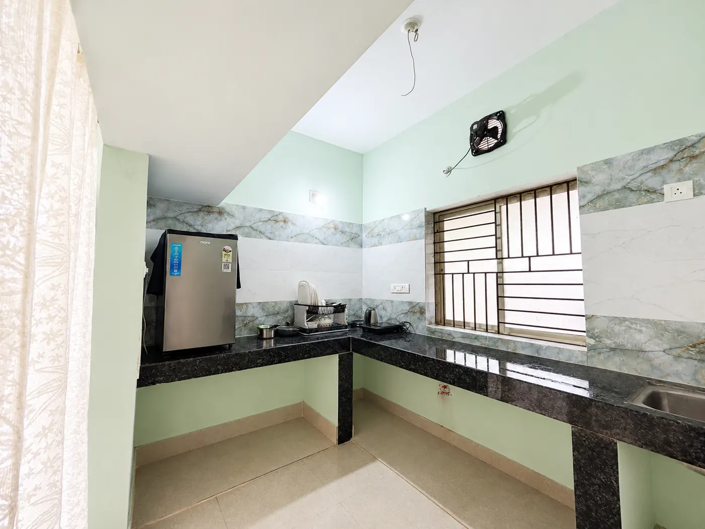 Kitchen with fridge and counter at Yostel Earth